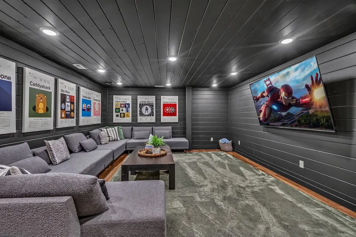 Home theater at Blue Smoke Lodge with tiered sectional seating and a wall-sized screen